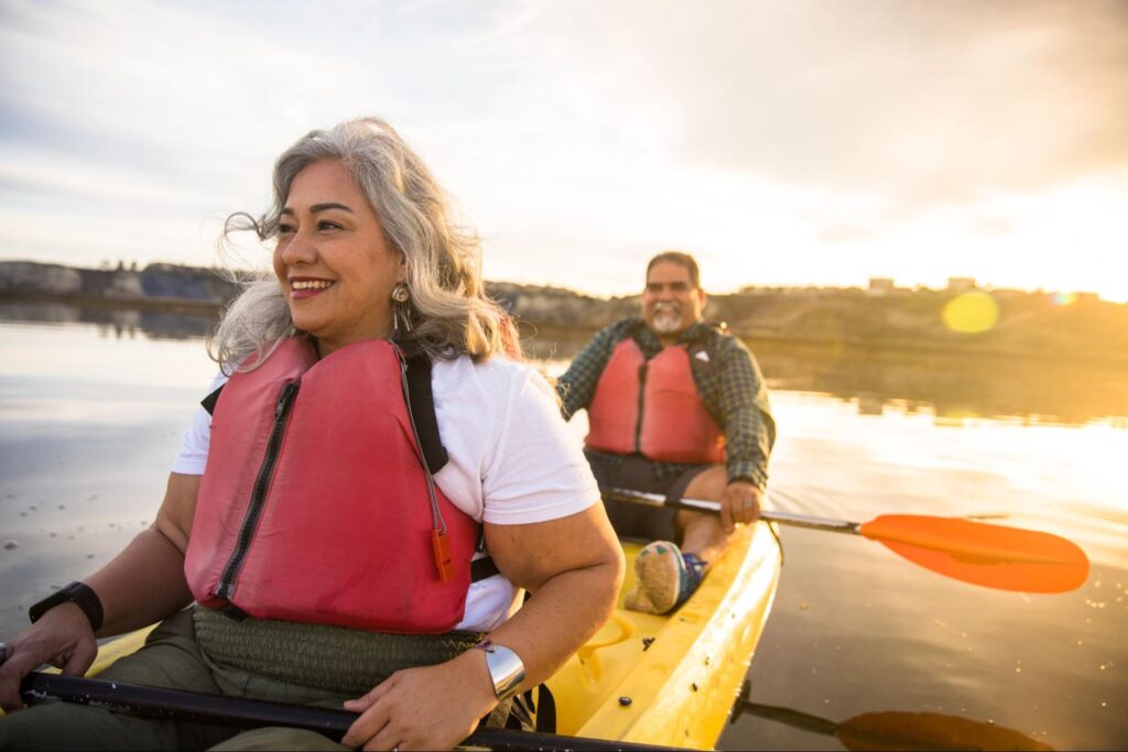 A happy senior Hispanic couple kayaking